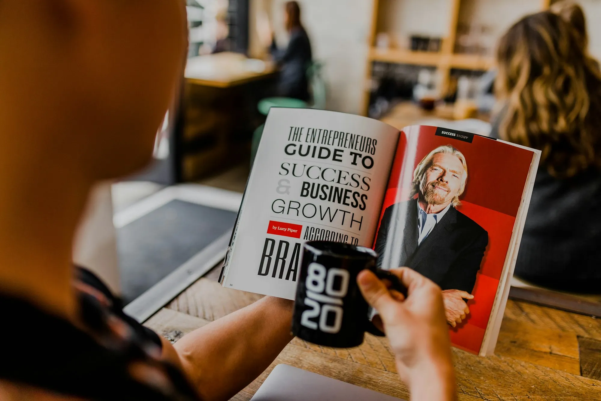 Reading a business growth magazine over coffee